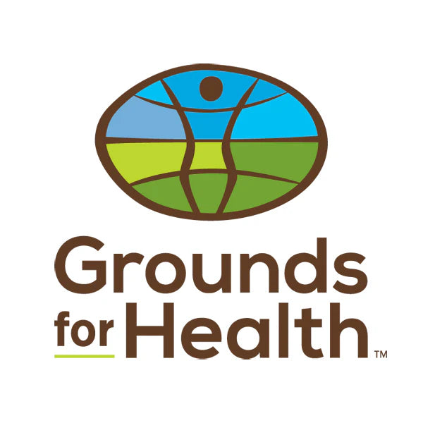 A stylized graphic logo of the world with a graphic line illustration of a woman with arms raised up. Text reads "Grounds for Health" under the logo