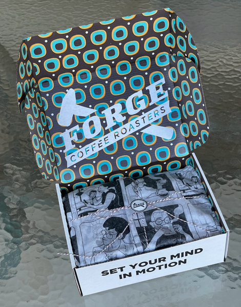 Forge Coffee Roasters Holiday Gift Box with drawn characters drinking coffee on the surfaces of the box.  Box is open, revealing tissue, twine and logo sticker seal