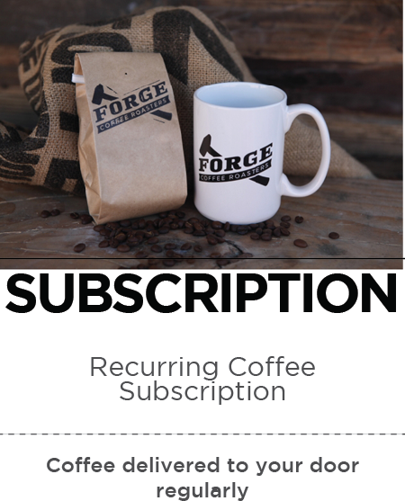 an image of a bag of coffee with the Forge Coffee Roasters logo next to a white ceramic mug also featuring the Forge Coffee Roasters logo.  Coffee beans are scattered on a wood surface. Text in image reads "SUBSCRIPTION recurring coffee subscription, coffee delivered to your door regularly"