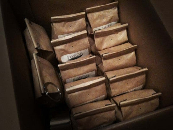 an image of 12 bags of coffee packed into an open cardboard box.